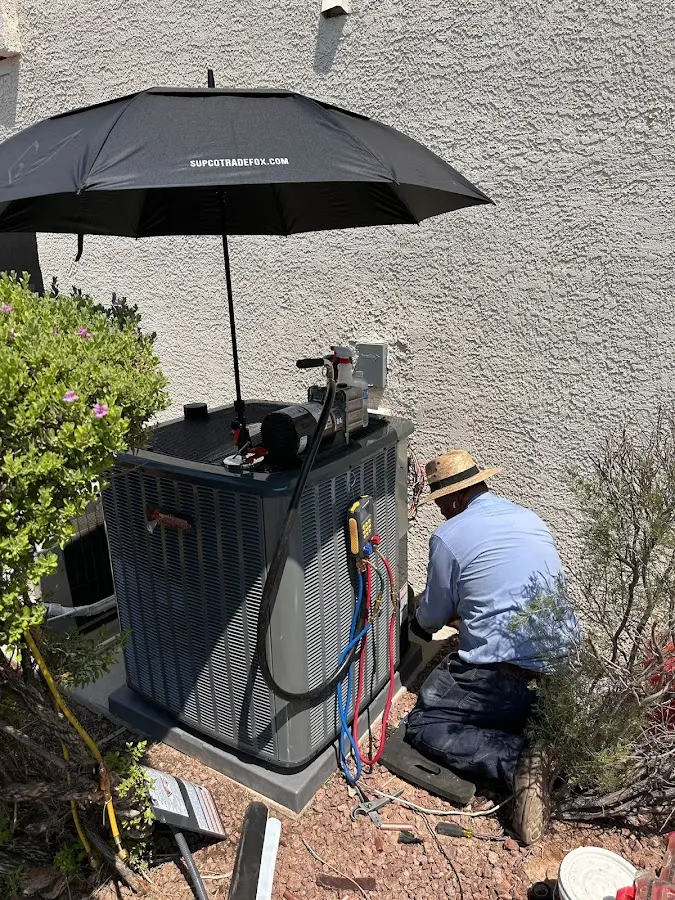 HVAC technician performing outdoor AC maintenance in Woodlawn